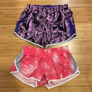 2 pairs of Nike Dri-Fit running shorts. Pink shorts are size L, purple size XL.